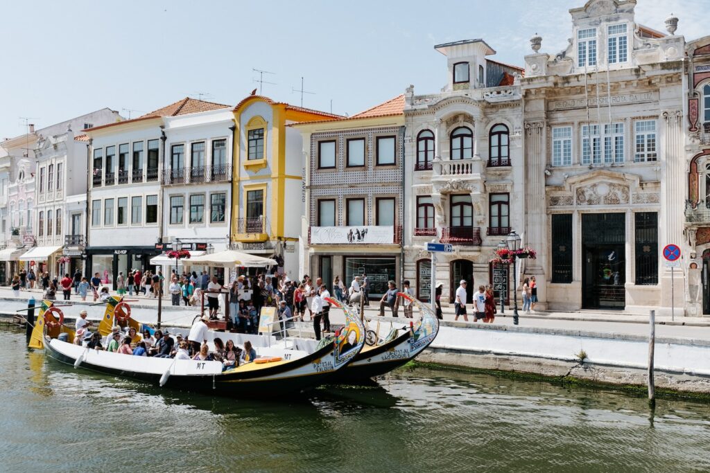 people in boat in front of buildings