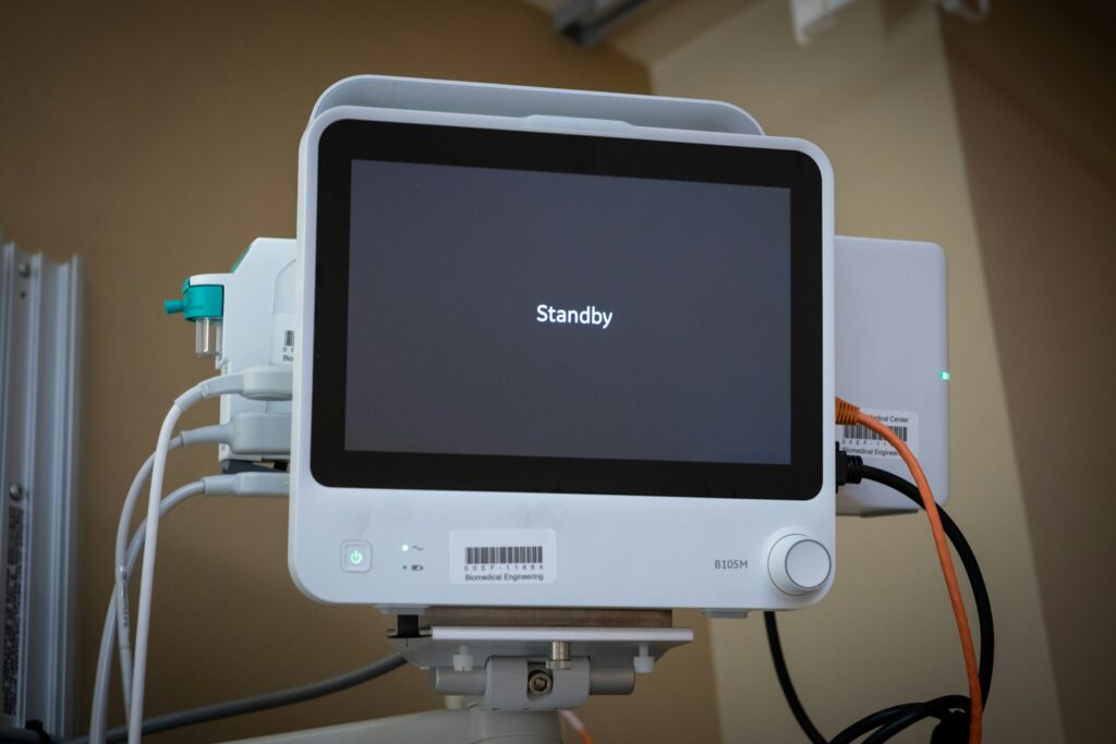 A medical device displays "standby" on its screen.