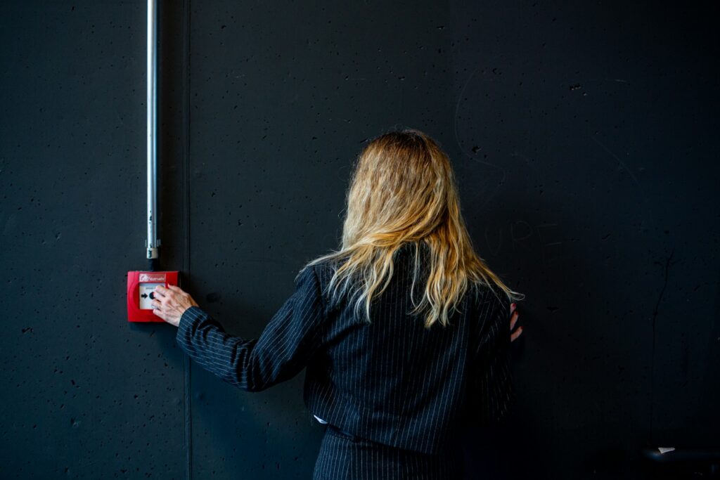A woman is holding a red light switch