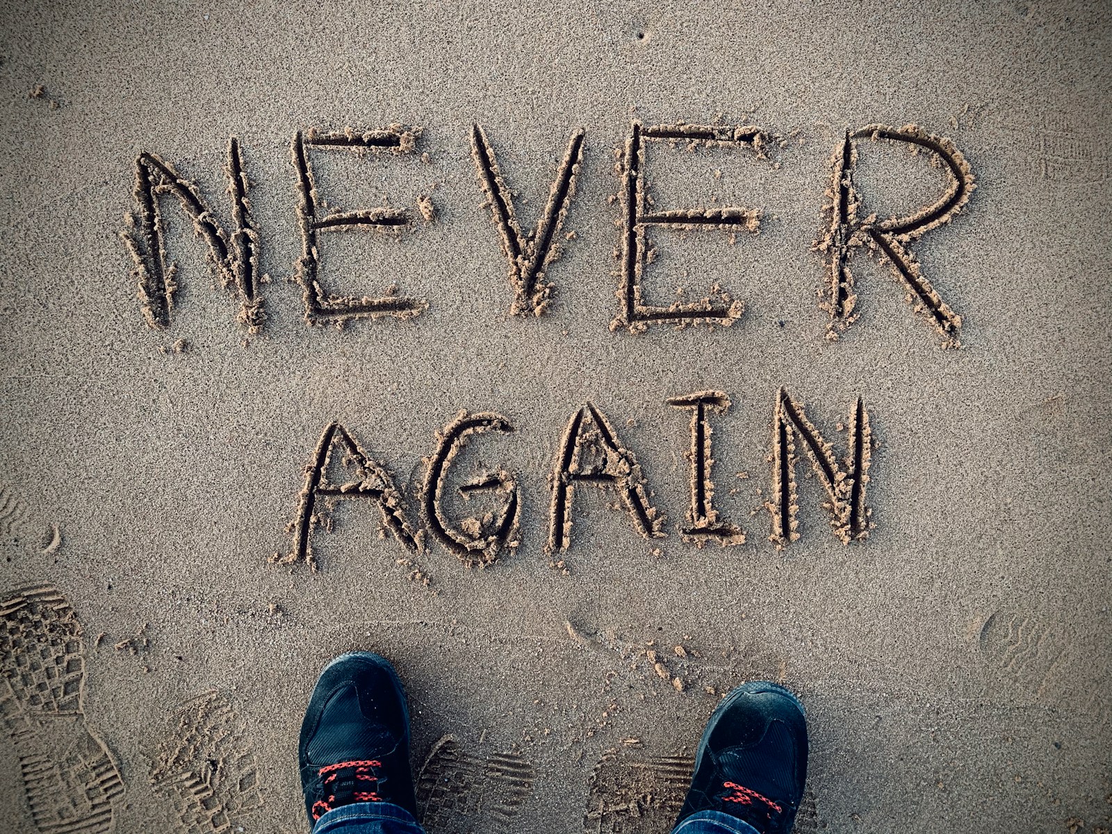 never again sand writing