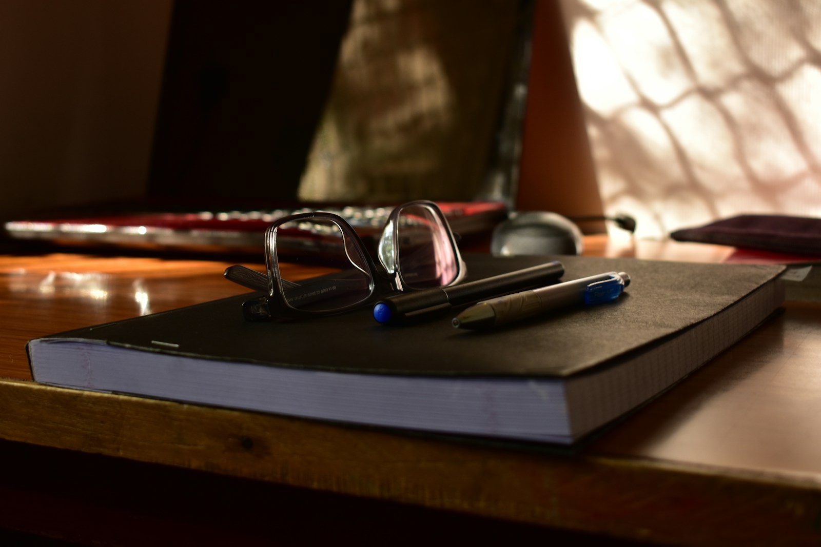 Glasses and pens on a notebook