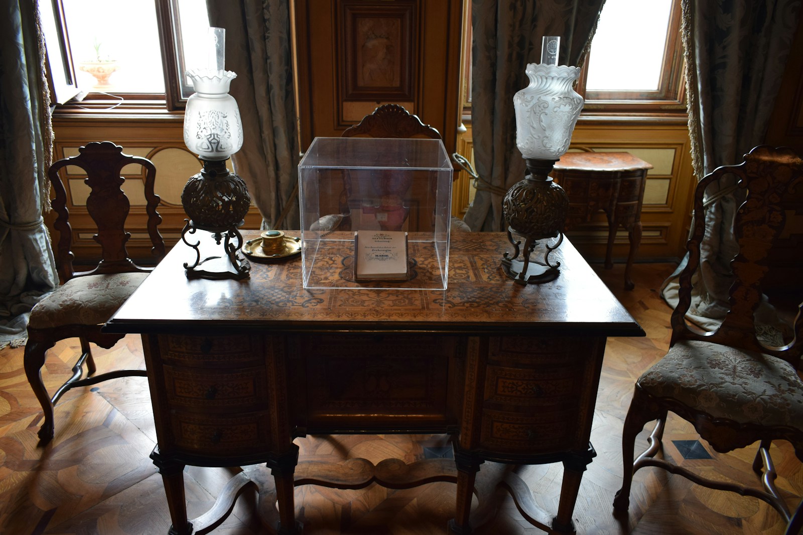 Antique desk with glass display case and lamps