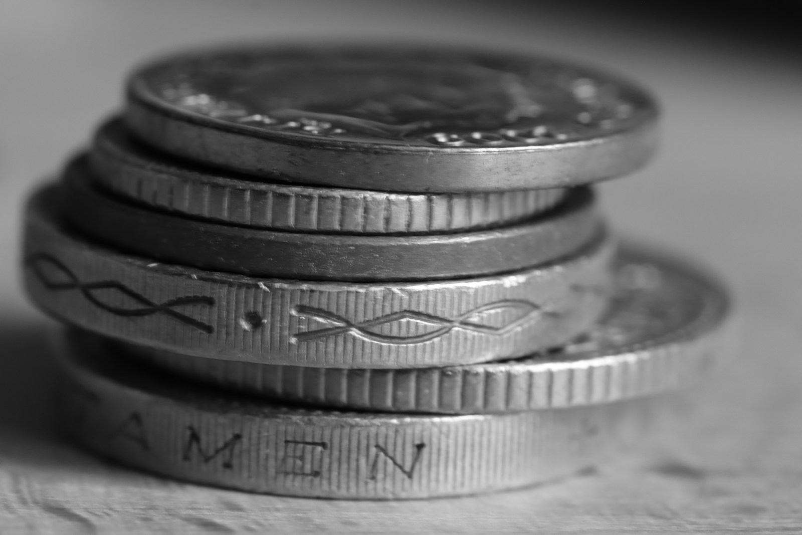a stack of silver coins sitting on top of a table
