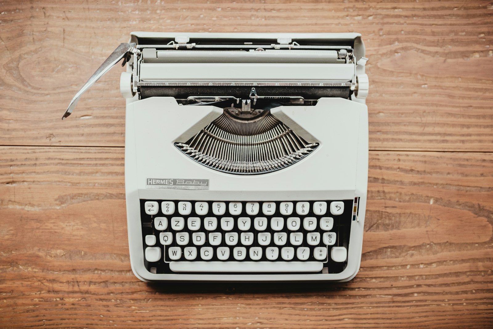 white and black typewriter on table