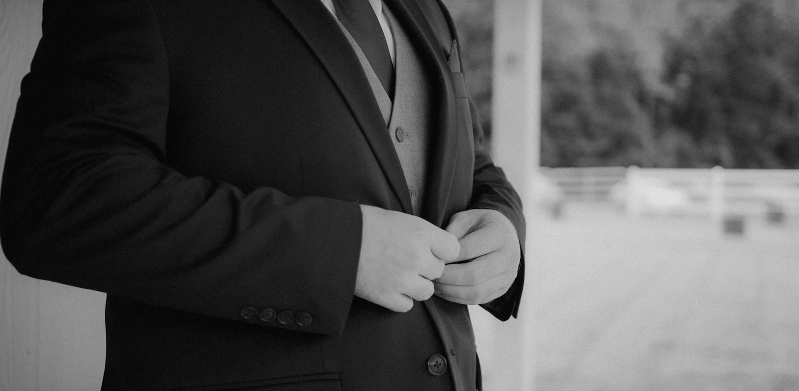 a black and white photo of a man in a suit